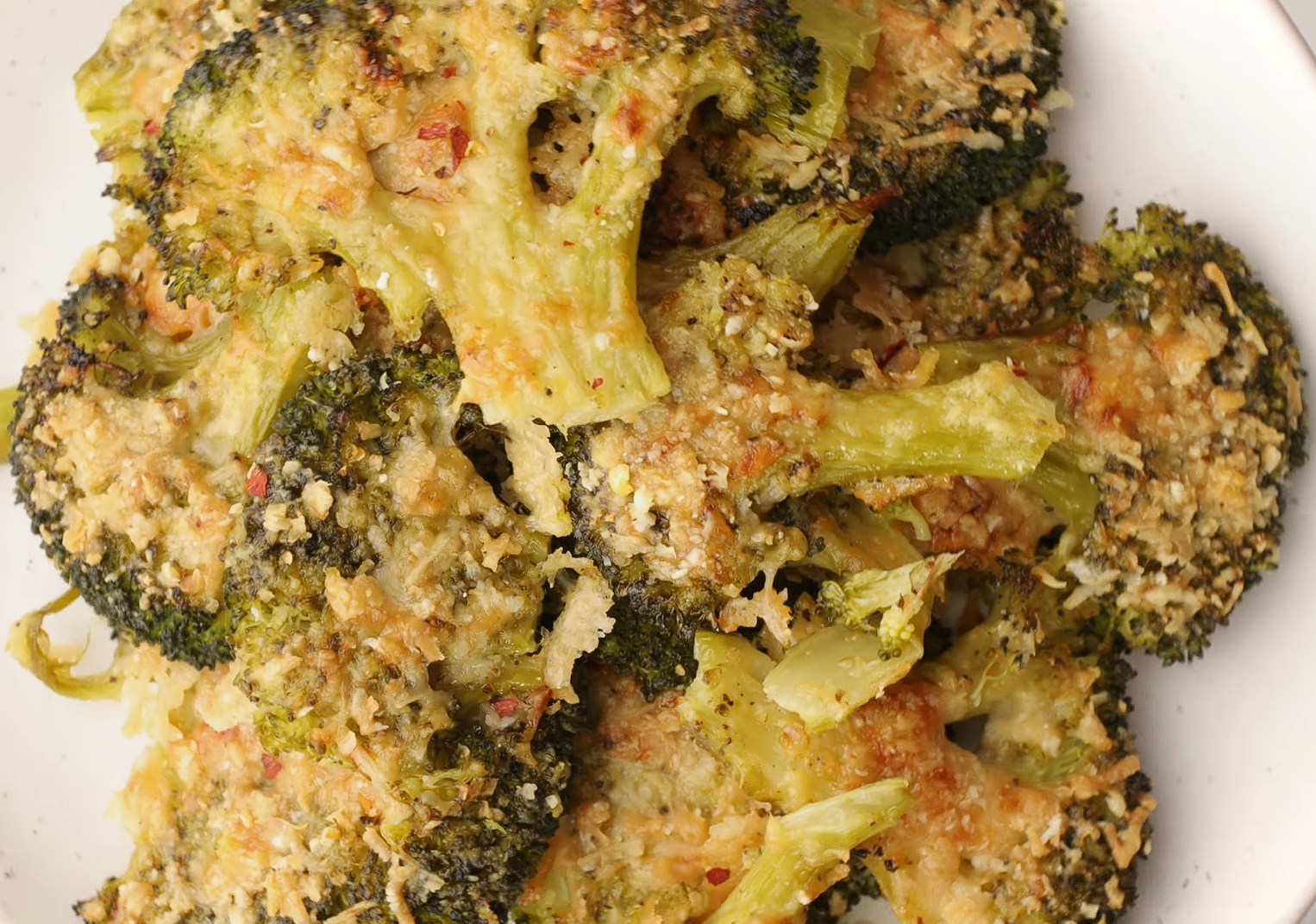 Close-up of smashed broccoli on a white plate