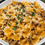 Savory garlic butter beef served with cheesy bowtie pasta, creating a creamy, flavorful dish.