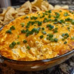 Cheesy creamy Buffalo Chicken Dip served in a bowl with tortillas