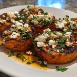 Roasted sweet potato rounds topped with honey and feta cheese