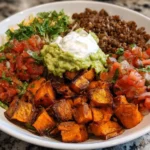 Colorful sweet potato taco bowl with toppings and fresh ingredients