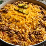 Cheesy one-pot cheeseburger orzo served in a bowl with fresh herbs