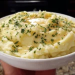 Bowl of creamy garlic mashed potatoes topped with parsley