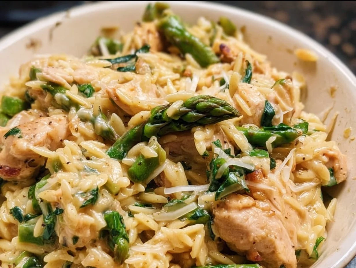 High Protein Chicken Orzo with vegetables and herbs in a bowl.