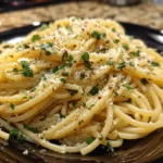 Delicious Italian pasta served with garlic olive oil sauce, garnished with herbs.