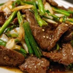 Delicious plate of Mongolian Beef with tender beef slices and green onions