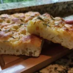 Homemade overnight focaccia bread with olive oil and herbs