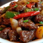 Sizzling Chinese pepper steak with onions served on a plate