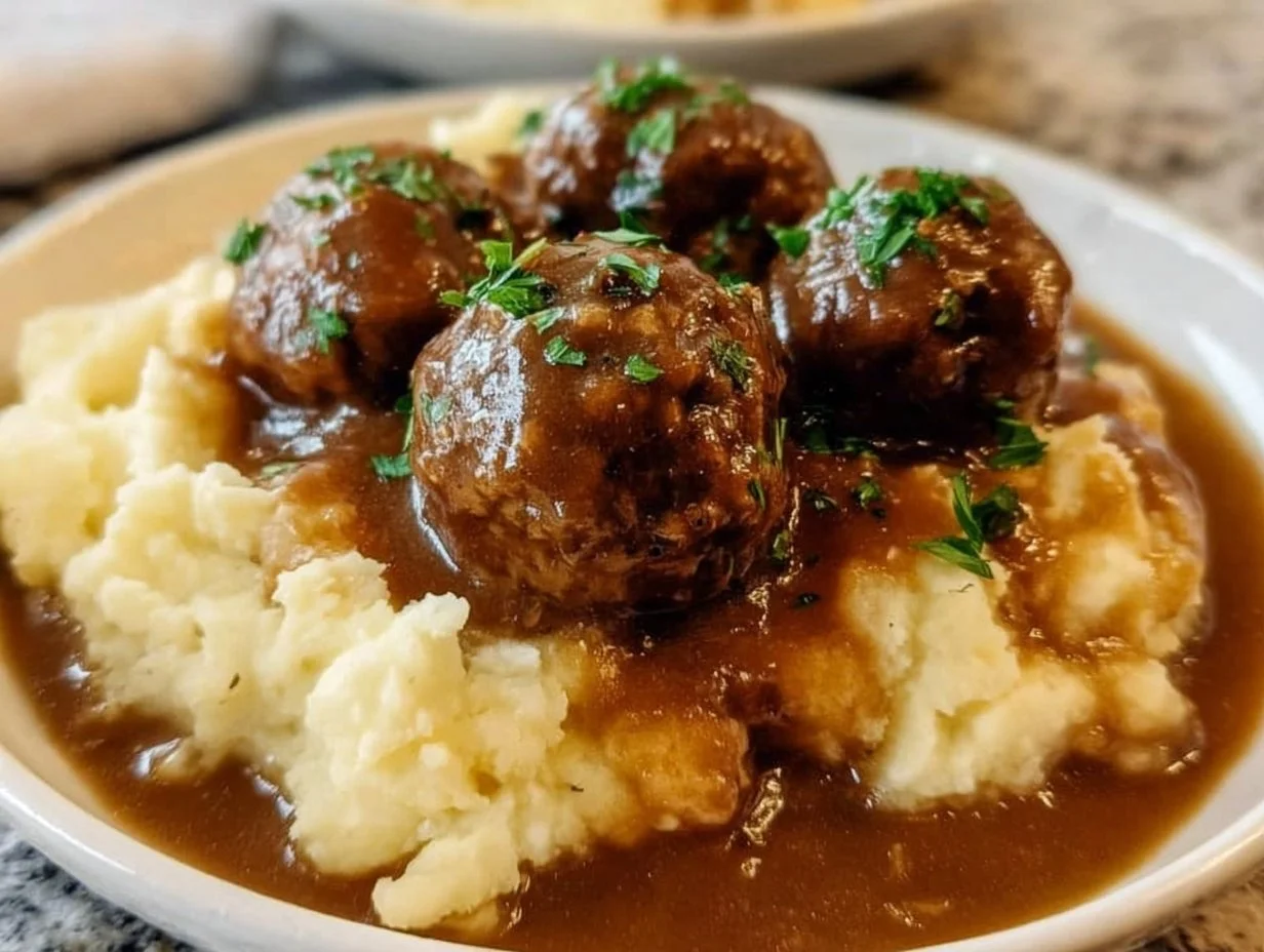 Slow Cooker Salisbury Steak Meatballs served with gravy and vegetables.