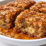 Freshly baked Banana Oatmeal Bars on a wooden table