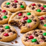 Christmas chocolate chip cookies with M&M's on a festive baking tray