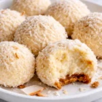 Coconut Snowball Cheesecake Bites served on a platter with toppings.