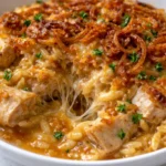 French Onion Chicken Orzo Casserole topped with melted cheese and herbs