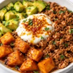 Hot Honey Ground Turkey Bowl garnished with fresh vegetables and spices.