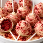 Delicious red velvet cake pops topped with cream cheese frosting.