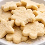 Plate of freshly baked sugar cookies with decorative sprinkles