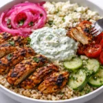 Loaded Mediterranean Chicken Bowl topped with Tzatziki and Feta cheese