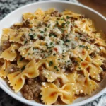 Creamy beef bowtie pasta with Parmesan sauce in a serving bowl