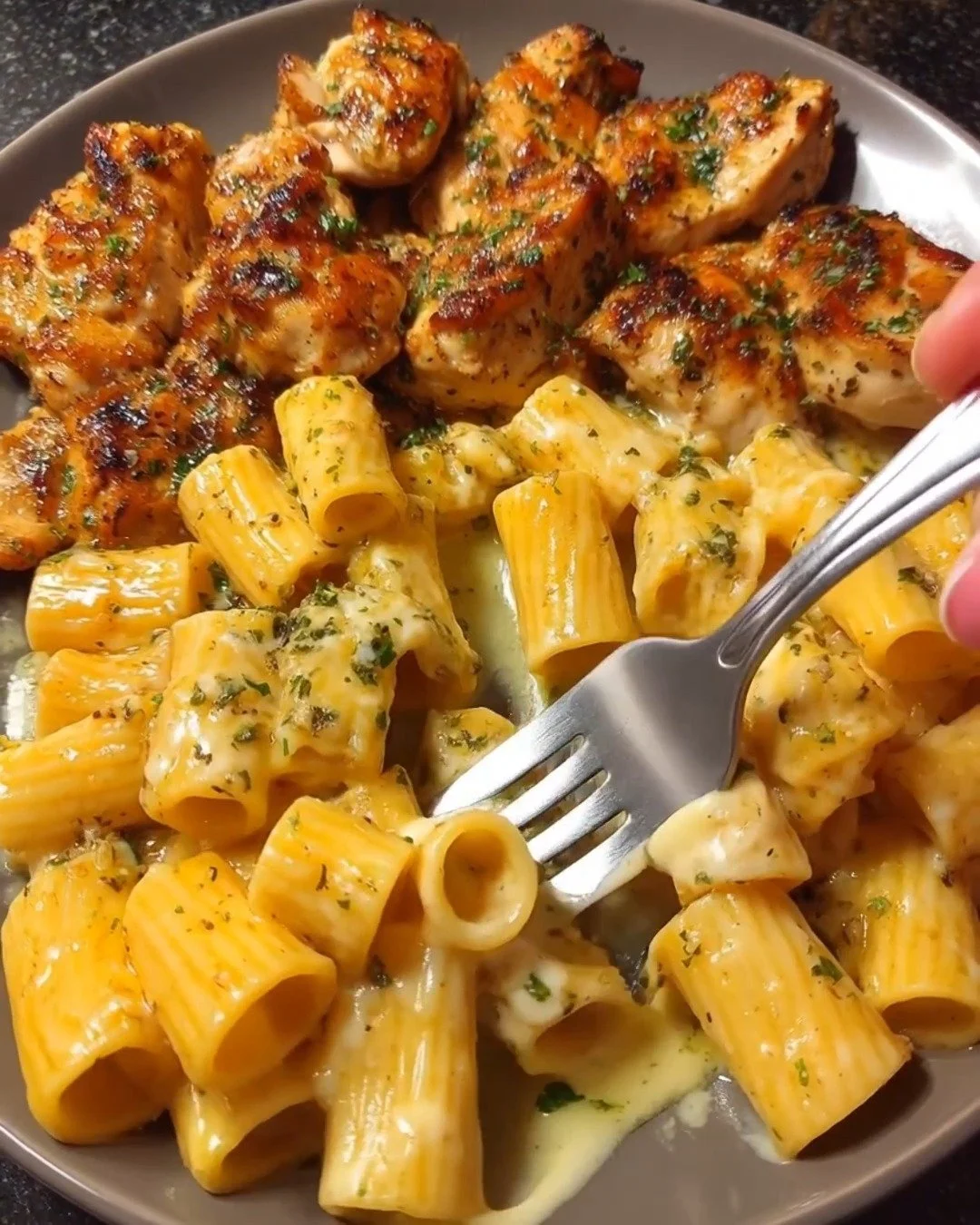 Creamy butter chicken rigatoni with cheddar sauce served in a bowl