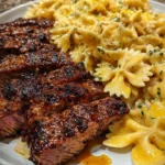 Delicious Cajun garlic butter steak served over pasta for a family dinner