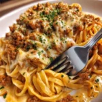 Creamy garlic butter beef linguine served on a white plate with herbs