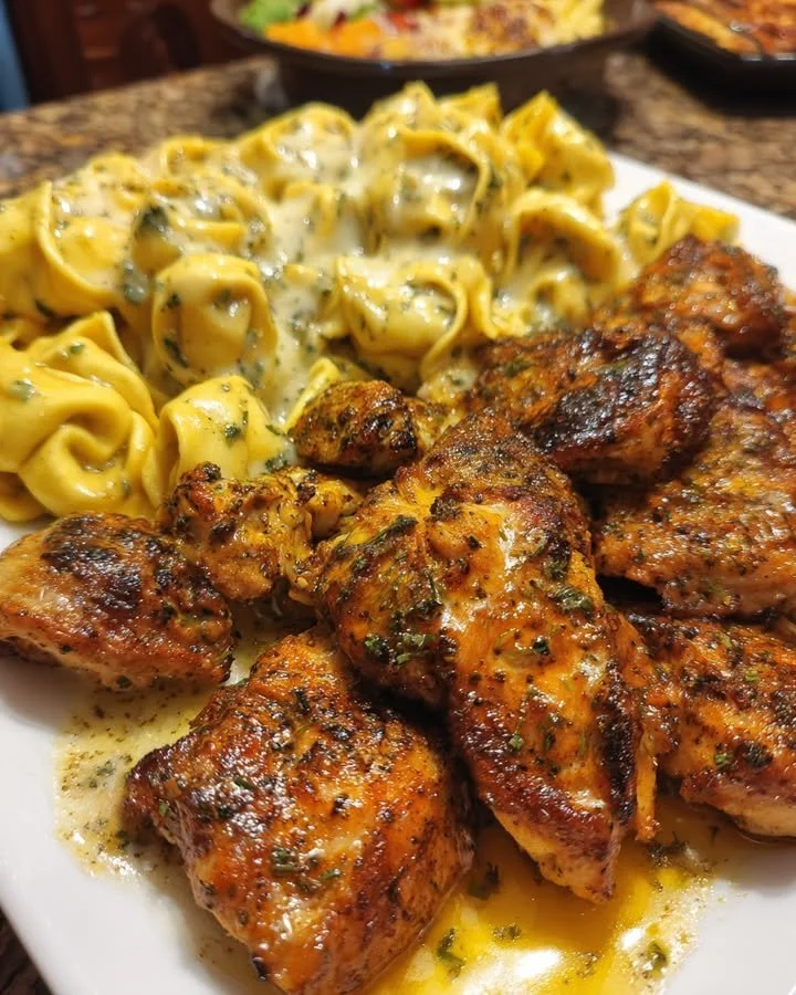 Creamy garlic butter chicken tortellini topped with Parmesan cheese