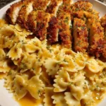 Baked Caesar Chicken with Parmesan Bowtie Pasta served on a plate