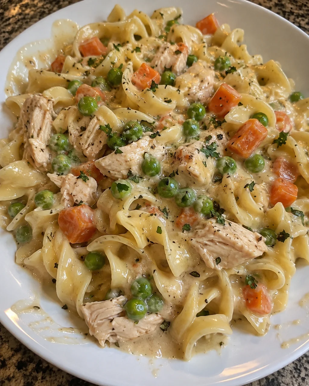 Delicious Chicken Pot Pie Pasta topped with creamy sauce and vegetables