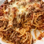 Delicious Cream Cheese Baked Spaghetti topped with cheese and herbs.