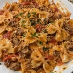 Delicious creamy bowtie pasta with ground beef served in a bowl.