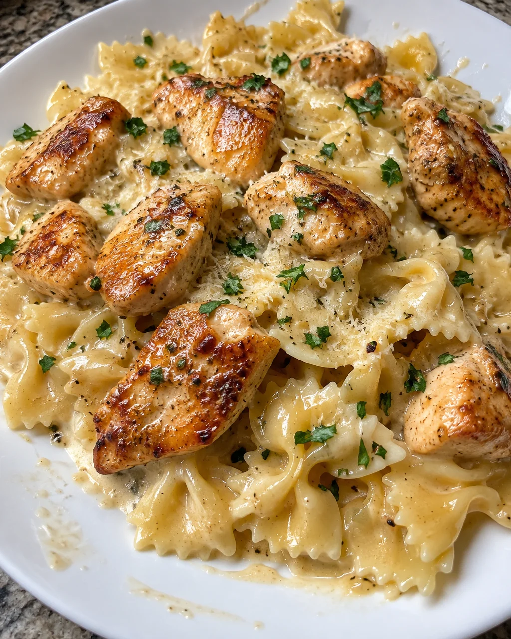 Delicious Creamy Bowtie Pasta with Lemon Garlic Chicken on a plate