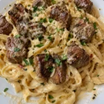 Creamy Parmesan pasta with garlic butter steak bites served in a bowl