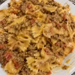 Creamy Velveeta bowtie pasta with beef in a bowl garnished with parsley