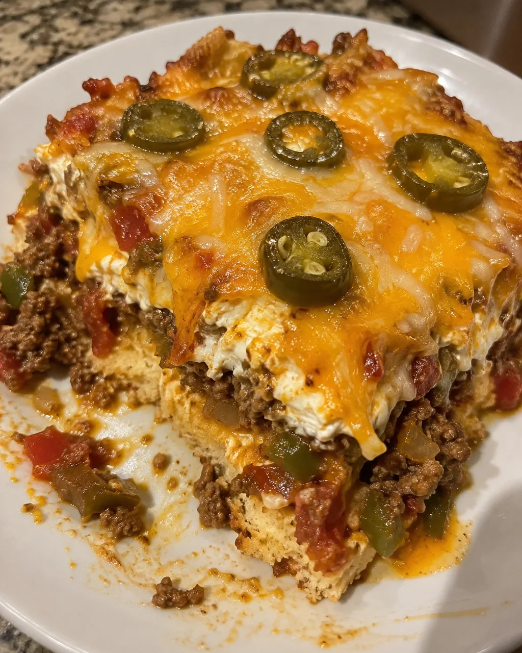 A delicious serving of John Wayne's Casserole topped with cheese and fresh herbs.