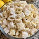Lemonade Puppy Chow Snack Mix in a bowl with a refreshing lemon theme